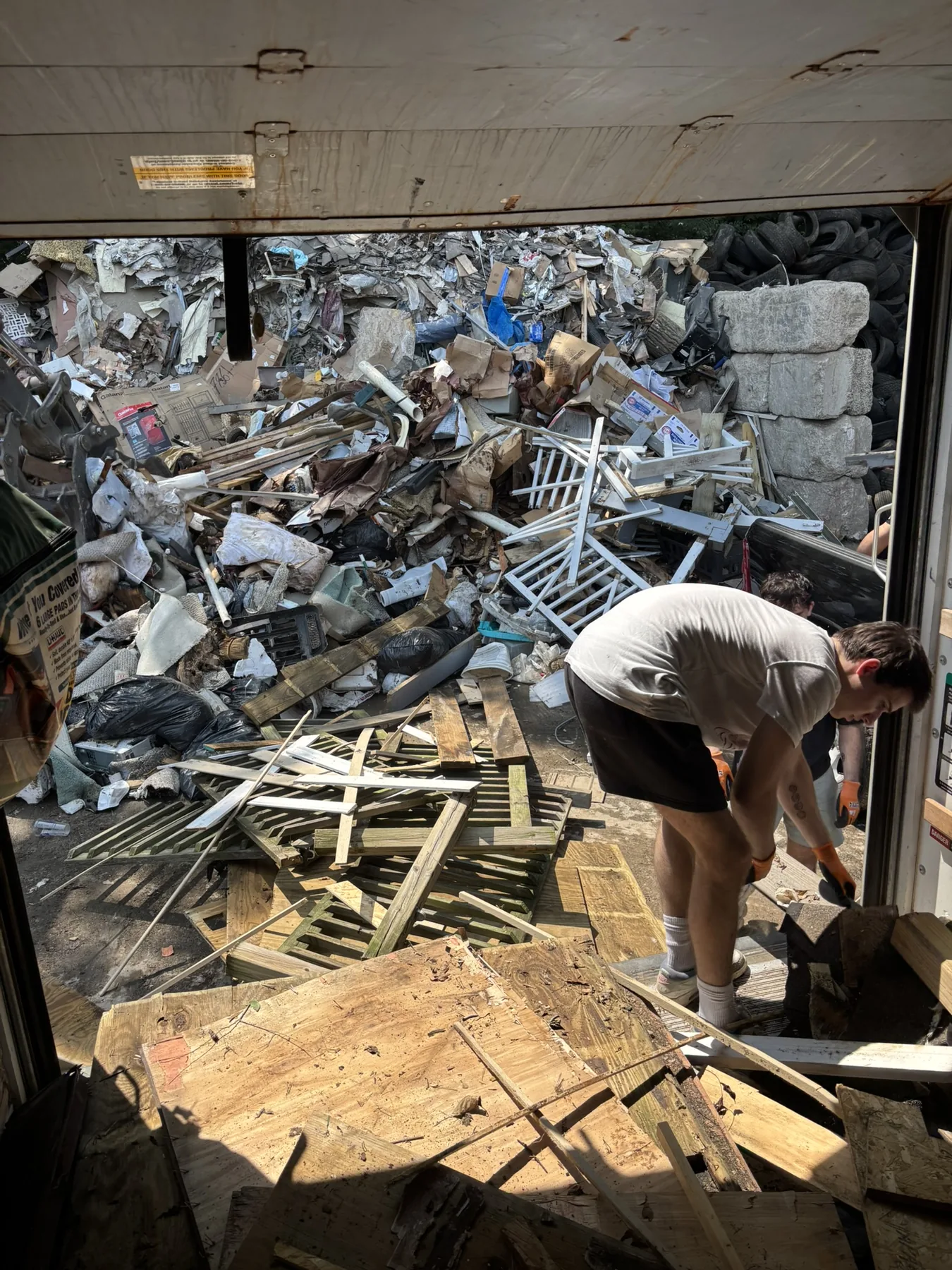Junkernauts Junk Removal crew unloading debris at a local transfer station